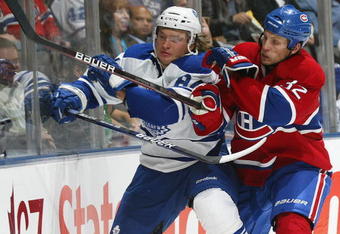TORONTO, ON - OCTOBER 1:  Travis Moen #32 of the Montreal Canadiens battles with Mikhail Grabovski #84 of the Toronto Maple Leafs for puck posession in a game on October 1, 2009 at the Air Canada Centre in Toronto, Ontario. The Canadiens dfeated the Leafs 4-3 in overtime. (Photo by Claus Andersen/Getty Images)