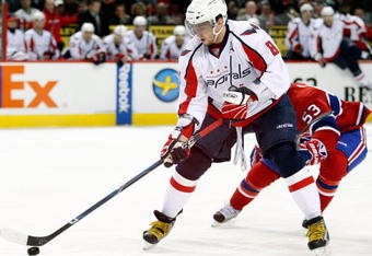 MONTREAL- NOVEMBER 28:  Alex Ovechkin #8 of the Washington Capitals skates with the puck while being defended by Ryan White #53 of the Montreal Canadiens during the NHL game on November 28, 2009 at the Bell Centre in Montreal, Quebec, Canada.  The Capitals defeated the Canadiens 4-3 in a shootout.  (Photo by Richard Wolowicz/Getty Images)