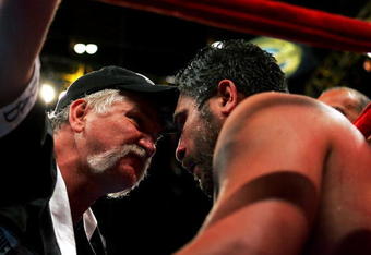 NEW YORK - APRIL 30:  John Ruiz' trainer Norman Stone (L) talks to Ruiz in his corner during his WBA Heavyweight Championship bout against James Toney at Madison Square Garden on April 30, 2005 in New York City.  (Photo by Chris Trotman/Getty Images)