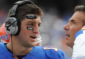 GAINESVILLE, FL - NOVEMBER 21: Quarterback Tim Tebow #15 of the Florida Gators talks with coach Urban Meyer against the Florida International University Golden Panthers, November 21, 2009 at Ben Hill Griffin Stadium in Gainesville, Florida.  (Photo by Al Messerschmidt/Getty Images)