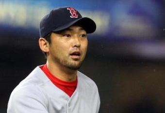 NEW YORK - MAY 05:  Takashi Saito #24 of the Boston Red Sox flips the ball to first base for an out against the New York Yankees on May 5, 2009 at Yankee Stadium in the Bronx borough of New York City. The Red Sox defeated the Yankees 7-3.  (Photo by Jim McIsaac/Getty Images)