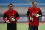 HANGZHOU, CHINA - JULY 25:  Goalkeeper Tomasz Kuszczak (L) and  Edwin Van der Sar (R) of Manchester United train during a training session as part of the club's Asia Tour 2009 at Huang Long Stadium on July 25, 2009 in Hangzhou, China. Manchester United will play a friendly match with Hangzhou Greentown in Hangzhou of China.  (Photo by Feng Li/Getty Images)