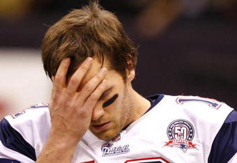 NEW ORLEANS - NOVEMBER 30: Quarterback Tom Brady #12 of the New England Patriots wipes his forehead with his hand during warm ups  against the New Orleans Saints at Louisana Superdome on November 30, 2009 in New Orleans, Louisiana. (Photo by Scott Halleran/Getty Images)
