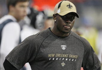 HOUSTON - AUGUST 22:  Running back Reggie Bush of the New Orleans Saints looks on from the sidelines against the Houston Texans on August 22, 2009 in Houston, Texas. An injured calf prevented him from playing.  (Photo by Bob Levey/Getty Images)