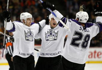 ANAHEIM, CA - DECEMBER 01:  (L-R) Jack Johnson #3, Randy Jones #12 and Jarret Stoll #28 of the Los Angeles Kings celebrate Johnson's go-ahead goal in the third period against the Anaheim Ducks at the Honda Center on December 1, 2009 in Anaheim, California. The Kings defeated the Ducks 4-3.  (Photo by Jeff Gross/Getty Images)