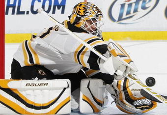 DETROIT - NOVEMBER 03: Tim Thomas #30 of the Boston Bruins makes a second period save while playing the Detroit Red Wings on November 3, 2009 at Joe Louis Arena in Detroit, Michigan.  (Photo by Gregory Shamus/Getty Images)