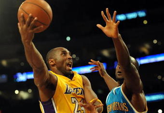 LOS ANGELES, CA - DECEMBER 01:  Kobe Bryant #24 of the Los Angeles Lakers goes in for a layup around Emeka Okafor #50 of the New Orleans Hornets during the first half at Staples Center on December 1, 2009 in Los Angeles, California. NOTE TO USER: User expressly acknowledges and agrees that, by downloading and/or using this Photograph, user is consenting to the terms and conditions of the Getty Images License Agreement.  (Photo by Harry How/Getty Images)