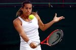 WIMBLEDON, ENGLAND - JUNE 27:  Amelie Mauresmo of France plays a backhand during the women's singles third round match against Flavia Pennetta of Italy on Day Six of the Wimbledon Lawn Tennis Championships at the All England Lawn Tennis and Croquet Club on June 27, 2009 in London, England.  (Photo by Ian Walton/Getty Images)