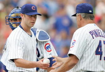 CHICAGO, IL- JULY 12:  Pitcher Rich Harden #40 of the Chicago Cubs hands the baseball to manager Lou Pinnella #41 against the San Francisco Giants at Wrigley Field on July 12, 2008 in Chicago, Illinois. (Photo by Scott Boehm/Getty Images)