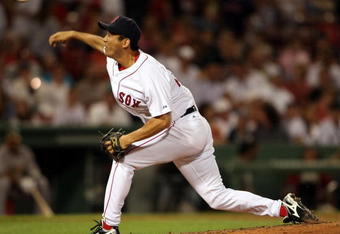 BOSTON - JULY 06:  Takashi Saito #24 of the Boston Red Sox delivers a pitch against the Oakland Athletics on July 6, 2009 at Fenway Park in Boston, Massachusetts. The Athletics defeated the Red Sox 6-0.  (Photo by Elsa/Getty Images)