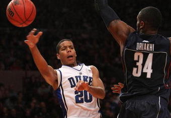 NEW YORK - NOVEMBER 27: Andre Dawkins #20 of the Duke Blue Devils passes around Alex Oriakhi #34 of the Connecticut Huskies during the Championship game at Madison Square Garden on November 27, 2009 in New York, New York.  (Photo by Nick Laham/Getty Images)