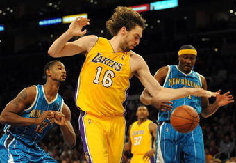 LOS ANGELES, CA - DECEMBER 01:  Pau Gasol #16 of the Los Angeles Lakers controls a rebound in front of James Posey #41 and Hilton Armstrong #12 of the New Orleans Hornets at Staples Center on December 1, 2009 in Los Angeles, California.  (Photo by Harry How/Getty Images) NOTE TO USER: User expressly acknowledges and agrees that, by downloading and/or using this Photograph, user is consenting to the terms and conditions of the Getty Images License Agreement.