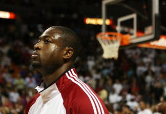 MIAMI - OCTOBER 28:  Dwyane Wade #3 of the Miami Heat stands for the National Anthem before taking on the New York Knicks at AmericanAirlines Arena on October 28, 2009 in Miami, Florida. The Heat defeated the Knicks 115-93. NOTE TO USER: User expressly acknowledges and agrees that, by downloading and/or using this Photograph, user is consenting to the terms and conditions of the Getty Images License Agreement.  (Photo by Doug Benc/Getty Images)