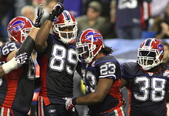 TORONTO - DECEMBER 3: Geoff Hangartner #63, Shawn Nelson #89, Marshawn Lynch #23 and Corey McIntyre #38 of the Buffalo Bills celebrate after Lynch scored a 15-yard rushing touchdown in the second quarter against the New York Jets at Rogers Centre on December 3, 2009 in Toronto, Canada.  (Photo by Rick Stewart/Getty Images)