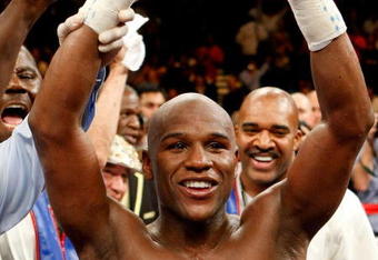 LAS VEGAS - SEPTEMBER 19:  Floyd Mayweather Jr., with his advisor Leonard Ellerbe behind him, celebrates his unanimous-decision victory over Juan Manuel Marquez at the MGM Grand Garden Arena September 19, 2009 in Las Vegas, Nevada.  (Photo by Ethan Miller/Getty Images)