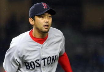 NEW YORK - MAY 05:  Takashi Saito #24 of the Boston Red Sox flips the ball to first base for an out against the New York Yankees on May 5, 2009 at Yankee Stadium in the Bronx borough of New York City. The Red Sox defeated the Yankees 7-3.  (Photo by Jim McIsaac/Getty Images)