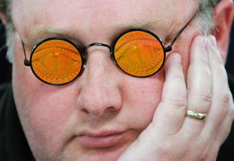 LAS VEGAS - JULY 30:  Poker player Greg 'Fossilman' Raymer, the 2004 World Series of Poker champion, wears his holographic glasses as he competes on the third day of the first round of the WSOP no-limit Texas Hold 'em main event at the Rio Hotel & Casino July 30, 2006 in Las Vegas, Nevada. More than 8,600 players have registered to play in the main event. The final nine players will compete for the top prize of more than USD 11.7 million on the final table which begins August 10.  (Photo by Ethan Miller/Getty Images)