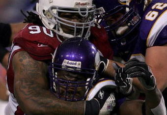 MINNEAPOLIS, MN - NOVEMBER 26: Darnell Dockett #90 of the Arizona Cardinals tackles Chester Taylor #29 of the Minnesota Vikings November 26, 2006 at the Hubert H. Humprey Metrodome in Minneapolis, Minnesota.  (Photo by Matthew Stockman/Getty Images)