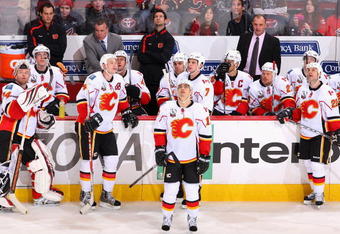 GLENDALE, AZ - DECEMBER 03:  (L-R) Goaltender Miikka Kiprusoff #34, Jay Bouwmeester #4, Rene Bourque #17, head coach Brent Sutter, Daymond Langkow #22 and the Calgary Flames bench look up at the scoreboard during the NHL game against the Phoenix Coyotes at Jobing.com Arena on December 3, 2009 in Glendale, Arizona.  The Coyotes defeated the Flames 2-1. (Photo by Christian Petersen/Getty Images)