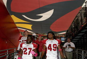 GLENDALE, AZ - OCTOBER 11: (L-R) Kurt Warner #13, Michael Adams #27 and Rashad Johnson #49 of the Arizona Cardinals walk off the field following warm ups to the NFL game against the Houston Texans at the Universtity of Phoenix Stadium on October 11, 2009 in Glendale, Arizona. (Photo by Christian Petersen/Getty Images)