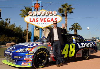 LAS VEGAS - DECEMBER 02:  2009 NASCAR Sprint Cup Series Champion Jimmie Johnson poses with the trophy next to the #48 Lowe's Chevrolet during Day 1 of the NASCAR Sprint Cup Series Champions Week on December 2, 2009 in Las Vegas, Nevada.  (Photo by Rusty Jarrett/Getty Images for NASCAR)