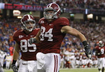 ATLANTA - DECEMBER 5:  Colin Peek #84 and Preston Dial #85 of the Alabama Crimson Tide celebrate after Peek scored a 17-yard touchdown in the third quarter against the Florida Gators during the SEC Championship game at Georgia Dome on December 5, 2009 in Atlanta, Georgia.  (Photo by Chris Graythen/Getty Images)