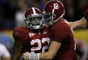 ATLANTA - DECEMBER 5:  (L-R) Mark Ingram #22 and quarterback Greg McElroy #12 of the Alabama Crimson Tide celebrate after Ingram scored a 1-yard touchdown in the fourth quarter against the Florida Gators during the SEC Championship game at Georgia Dome on December 5, 2009 in Atlanta, Georgia.  (Photo by Kevin C. Cox/Getty Images)