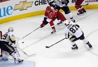 RALEIGH, NC - MAY 26:  Rod Brind'Amour #17 of the Carolina Hurricanes handles the puck against Sidney Crosby #87 and goalie Marc-Andre Fleury #29 of the Pittsburgh Penguins during Game Four of the Eastern Conference Championship Round of the 2009 Stanley Cup Playoffs at RBC Center on May 26, 2009 in Raleigh, North Carolina.   (Photo by Kevin C. Cox/Getty Images)