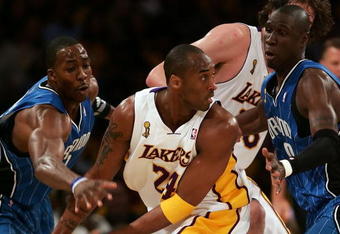 LOS ANGELES, CA - JUNE 07:  Kobe Bryant #24 of the Los Angeles Lakers has the ball as he looks to pass as he is covered by Dwight Howard #12 and Mickael Pietrus #20 of the Orlando Magic in the first quarter of Game Two of the 2009 NBA Finals at Staples Center on June 7, 2009 in Los Angeles, California. NOTE TO USER: User expressly acknowledges and agrees that, by downloading and or using this photograph, User is consenting to the terms and conditions of the Getty Images License Agreement.  (Photo by Jed Jacobsohn/Getty Images)