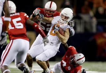 ARLINGTON, TX - DECEMBER 5:  Jordan Shipley #8 of the Texas Longhorns is stopped by Phillip Dillard #52 and Larry Asante #4 of the Nebraska Cornhuskers for a 15-yard penalty in the final minutes of the game at Cowboys Stadium on December 5, 2009 in Arlington, Texas.  Texas won the game 10-6.  (Photo by Jamie Squire/Getty Images)