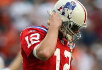 MIAMI - DECEMBER 06:  Quarterback Tom Brady #12 of the New England Patriots reacts after throwing an interception in the end-zone late in the fourth quarter against the Miami Dolphins at Land Shark Stadium on December 6, 2009 in Miami, Florida. The Dolphins defeated the Patriots 22-21.  (Photo by Doug Benc/Getty Images)
