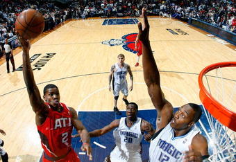 ATLANTA - NOVEMBER 26:  Joe Johnson #2 of the Atlanta Hawks shoots over Dwight Howard #12 of the Orlando Magic at Philips Arena on November 26, 2009 in Atlanta, Georgia.  NOTE TO USER: User expressly acknowledges and agrees that, by downloading and/or using this Photograph, User is consenting to the terms and conditions of the Getty Images License Agreement.  (Photo by Kevin C. Cox/Getty Images)