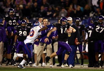 SAN DIEGO, CA - DECEMBER 23:  Quarterback Andy Dalton #14 of  TCU runs with the ball against the tackle of Safety Jeron Johnson #23 of Boise State during the San Diego County Credit Union Poinsettia Bowl at Qualcomm Stadium on December 23, 2008 in San Diego, California. (Photo by Donald Miralle/Getty Images)