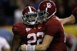 ATLANTA - DECEMBER 5:  (L-R) Mark Ingram #22 and quarterback Greg McElroy #12 of the Alabama Crimson Tide celebrate after Ingram scored a 1-yard touchdown in the fourth quarter against the Florida Gators during the SEC Championship game at Georgia Dome on December 5, 2009 in Atlanta, Georgia.  (Photo by Kevin C. Cox/Getty Images)