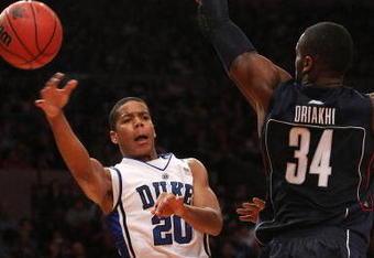 NEW YORK - NOVEMBER 27: Andre Dawkins #20 of the Duke Blue Devils passes around Alex Oriakhi #34 of the Connecticut Huskies during the Championship game at Madison Square Garden on November 27, 2009 in New York, New York.  (Photo by Nick Laham/Getty Images)