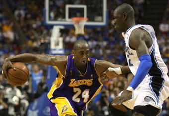 ORLANDO, FL - JUNE 14:  Kobe Bryant #24 of the Los Angeles Lakers moves the ball against Mickael Pietrus #20 of the Orlando Magic in Game Five of the 2009 NBA Finals on June 14, 2009 at Amway Arena in Orlando, Florida. The Lakers won 99-86. NOTE TO USER:  User expressly acknowledges and agrees that, by downloading and or using this photograph, User is consenting to the terms and conditions of the Getty Images License Agreement. (Photo by Elsa/Getty Images) 