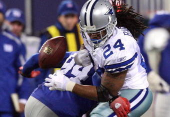 EAST RUTHERFORD, NJ - DECEMBER 06:  Marion Barber #24 of the Dallas Cowboys fumbles the ball as he is hit by Mathias Kiwanuka #94 of the New York Giants in the second quarter at Giants Stadium on December 6, 2009 in East Rutherford, New Jersey.  (Photo by Jim McIsaac/Getty Images)