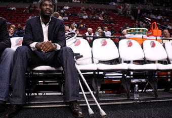 PORTLAND, OR - OCTOBER 10:  Greg Oden #52 of the Portland Trail Blazers, who is out for the season after under going micro fracture surgery in his knee, sits on the bench to watch a pre-season game against the Los Angeles Clippers at the Rose Garden on October 10, 2007 in Portland, Oregon.  NOTE TO USER: User expressly acknowledges and agrees that, by downloading and or using this Photograph, user is consenting to the terms and conditions of the Getty Images License Agreement.  (Photo by Jonathan Ferrey/Getty Images)