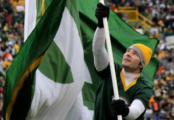 GREEN BAY, WI - NOVEMBER 16:  A Green Bay Packers cheerleader waves a flag in support of his team against the Chicago Bears during NFL action at Lambeau Field on November 16, 2008 in Green Bay, Wisconsin. The Packers defeated the Bears 37-3.  (Photo by Doug Pensinger/Getty Images)