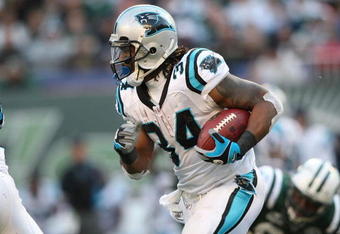 EAST RUTHERFORD, NJ - NOVEMBER 29:  DeAngelo Williams #34  of the Carolina Panthers rushes against the New York Jets at Giants Stadium on November 29, 2009 in East Rutherford, New Jersey.  (Photo by Nick Laham/Getty Images)