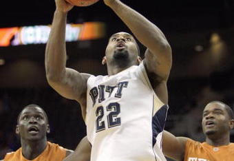 KANSAS CITY,MO - NOVEMBER 24:  Brad Wanamaker #22 of the Pittsburgh Panthers takes a shot against Alexis Wangmene #20 and Justin Mason #24 ofthe Texas Longhorns during the CBE Classic championship game on November 24, 2009 at Sprint Center in Kansas City, Missouri. (Photo by: Jamie Squire/Getty Images)
