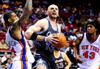 ORLANDO, FL - DECEMBER 02:  Marcin Gortat #13 of the Orlando Magic attempts a shot against Wilson Chandler #21 of the New York Knicks during the game at Amway Arena on December 2, 2009 in Orlando, Florida.  NOTE TO USER: User expressly acknowledges and agrees that, by downloading and/or using this Photograph, user is consenting to the terms and conditions of the Getty Images License Agreement.  (Photo by Sam Greenwood/Getty Images)