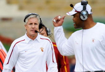 LOS ANGELES, CA - DECEMBER 05:  Coach Pete Carroll (L) of the USC Trojans talks with Ken Norton Jr., Assistant Head Coach of the Defense/Linebackers during the foruth quarter of the NCAA college football game against Arizona Wildcats at the Los Angeles Coliseum on December 5, 2009 in Los Angeles, California.  (Photo by Kevork Djansezian/Getty Images)