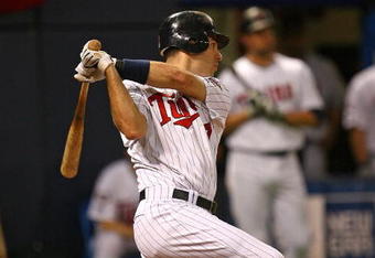 MINNEAPOLIS - OCTOBER 11: Joe Mauer #7 of the Minnesota Twins hits a run-scoring single in the 6th inning against the New York Yankees in Game Three of the ALDS during the 2009 MLB Playoffs at the Hubert H. Humphrey Metrodome on October 11, 2009 in Minneapolis, Minnesota. (Photo by Jonathan Daniel/Getty Images)