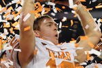 ARLINGTON, TX - DECEMBER 05:  Quarterback Colt McCoy #12 of the Texas Longhorns lifts the Big 12 Championship trophy at Cowboys Stadium on December 5, 2009 in Arlington, Texas.  (Photo by Ronald Martinez/Getty Images)