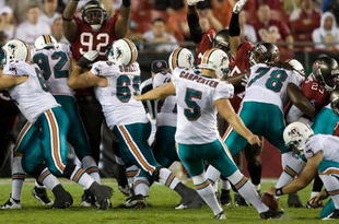 TAMPA, FL - AUGUST 27:  Defensive tackle Dre Moore #92 of the Tampa Bay Buccaneers attempts to block a field goal from kicker Dan Carpenter #5 of the Miami Dolphins during a preseason game at Raymond James Stadium on August 27, 2009 in Tampa, Florida.  (Photo by J. Meric/Getty Images)