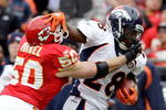 KANSAS CITY, MO - DECEMBER 06:  Correll Buckhalter #28 of the Denver carries the ball as Mike Vrabel #50 of the Kansas City Chiefs defends during the game on December 6, 2009 at Arrowhead Stadium in Kansas City, Missouri.  (Photo by Jamie Squire/Getty Images)