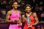 DOHA, QATAR - NOVEMBER 01:  Winner Serena Williams (R) of the USA holds the Billie Jean King trophy and poses for a photograph with her sister and runner up Venus Williams of the USA after the Women's final during the Sony Ericsson Championships at the Khalifa Tennis and Squash Complex on November 1, 2009 in Doha, Qatar.  (Photo by Clive Brunskill/Getty Images)