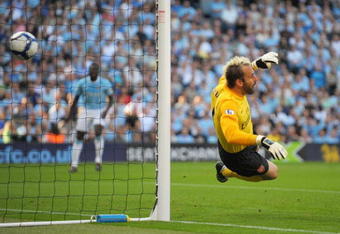 MANCHESTER, ENGLAND - SEPTEMBER 12:   Manuel Almunia of Arsenal concedes an own goal as he heads the ball into his own net after it rebounded off the post and hit him during the Barclays Premier League match between Manchester City and Arsenal at the City of Manchester Stadium on September 12, 2009 in Manchester, England. (Photo by Shaun Botterill/Getty Images)