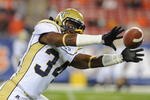 TAMPA, FL - NOVEMBER 28: Linebacker Steven Sylvester #34 of the Georgia Tech Yellow Jackets grabs a warmup pass against the Clemson Tigers in the 2009 ACC Football Championship Game December 5, 2009 at Raymond James Stadium in Tampa, Florida.  (Photo by Al Messerschmidt/Getty Images) 